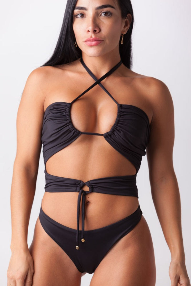This one-piece swimsuit offers a unique silhouette with the option to wear it strapless, crossed, or straight, making it a versatile addition to any beach or street wardrobe.  Silhouette with front cuts Adjustable neck strap Adjustable strap on waist cut No removable cups Adjustable strap on the back Panty gathered in rear Made in Colombia